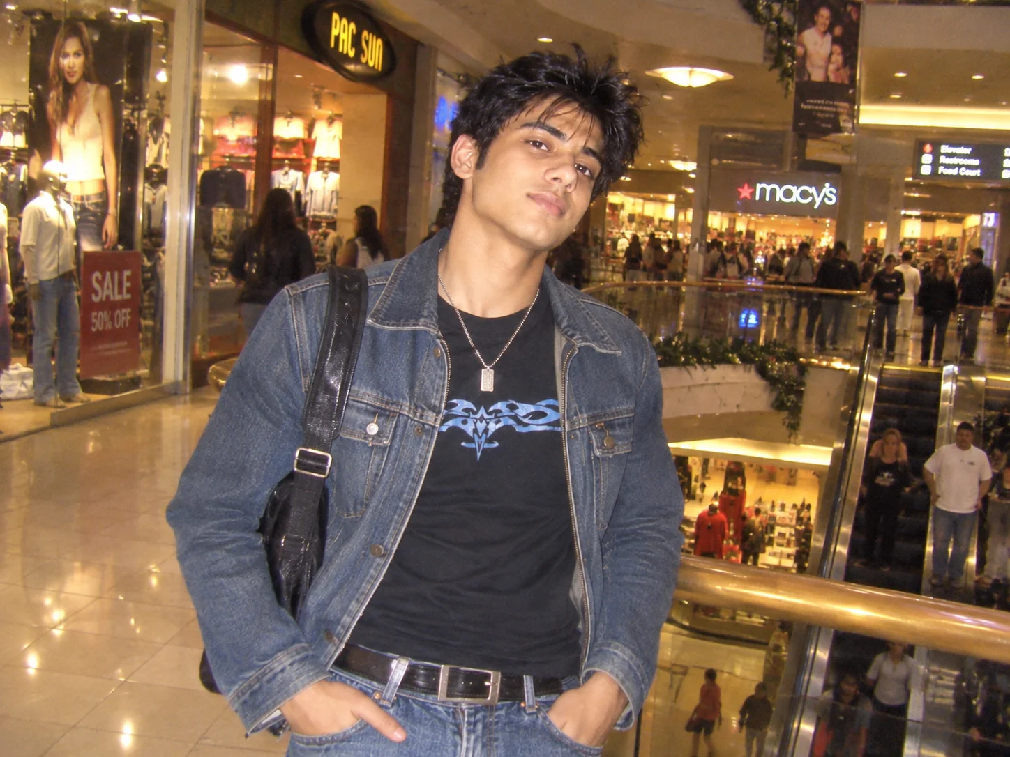 Early 2000s mall fashion photo with Y2K clothing and direct digital camera flash