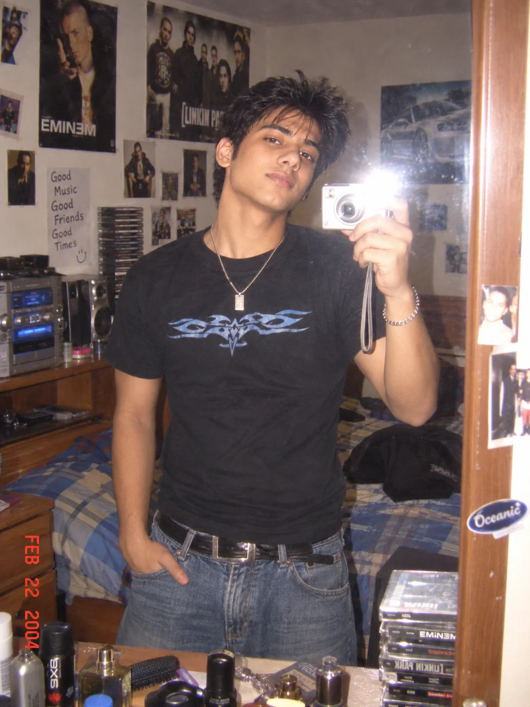 Y2K bedroom mirror selfie with compact digital camera flash and early 2000s decor